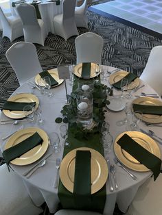 the table is set with green and gold place settings