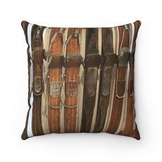 a brown and white pillow with lots of belts hanging on the wall in front of it