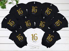 a group of black and white shirts with gold numbers on the front are arranged in a circle