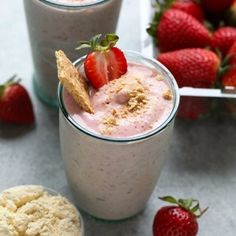 a strawberry milkshake is garnished with strawberries