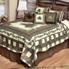 a bed with a green and brown quilt on it