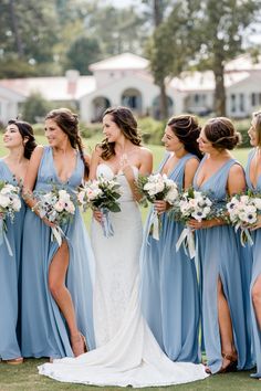 a bride and her bridesmaids in blue dresses