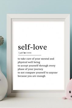 a white framed print with the words self love on it