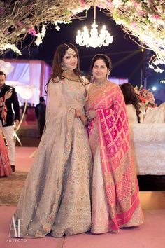 two women standing next to each other at a wedding