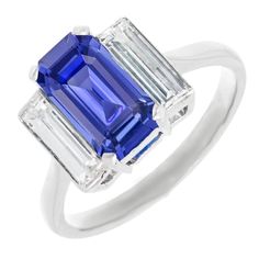 METAL SPECIFICATIONS White Gold 14K STONE SPECIFICATIONS Stone Name : Blue Sapphire and Diamond Stone Cut : Emerald and Baguette Stone Details : There is one emerald cut sapphire approx. 3 carats (Approx. Size 10 x 6 mm) and two baguette diamonds approx. 0.25 carats each ( Approx. Size 4.7 x 2.2 mm) on the sides. Natural earth mined stones. Color : G Clarity : VVS1 Quality of Sapphire : AAA Sapphire Treatment : Heated Total : Approx. 3.50 Carats RING SPECIFICATIONS Size : 6.5 (Can ship in any si Sapphire Emerald Cut Ring, Emerald Cut Ring, Emerald Cut Rings, Baguette Diamonds, Blue Sapphire Rings, 3 Carat, Natural Earth, Stone Cuts, Baguette Diamond