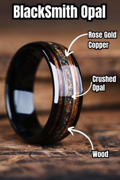 a black ceramic ring with wood inlays and the words blacksmith opal on it