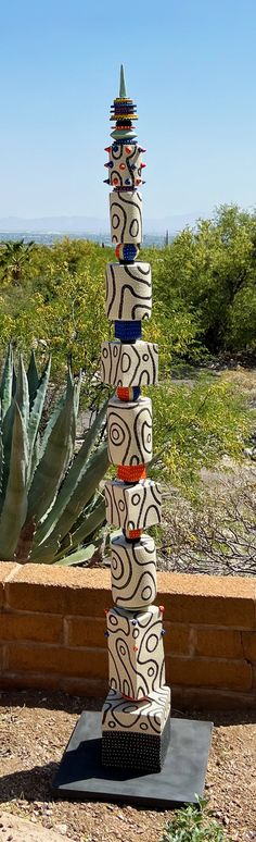 a tall tower made out of different types of objects on top of a wooden bench