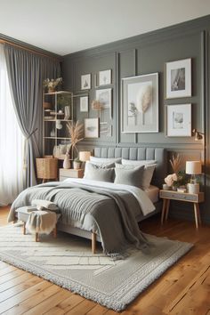 a bedroom with gray walls and wooden floors, pictures on the wall above the bed