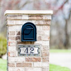 a brick mailbox with the number twenty four on it