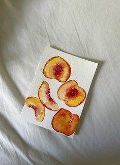 four pieces of fruit on top of a white sheet