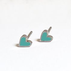 Beautifully dainty heart studs with mint enamel detail.  Made with silver plated stainless steel and a pop of enamel. Perfect gift to spread some love. Presented in a premium gift box. Trendy Blue Heart Earrings For Gift, Trendy Green Heart Earrings For Gift, Cute Green Heart Earrings For Gift, Green Nickel-free Heart Earrings As Gift, Trendy Sterling Silver Heart Earrings For Gift, Trendy Sterling Silver Heart Earrings As Gift, Cloisonne Enamel Jewelry, Enamel Stud Earrings, Cloisonne Enamel