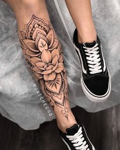 a woman's leg with a flower tattoo on it