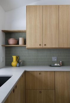 a kitchen with wooden cabinets and white counter tops