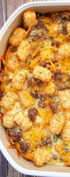 a casserole dish with meat and cheese in it sitting on a wooden table