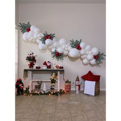 a room decorated for christmas with balloons and decorations