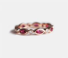 an image of a wedding ring with pink stones