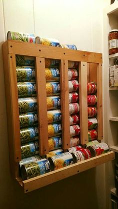 an organized spice rack with canned food in it