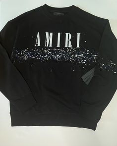 This AMIRI sweatshirt is a wardrobe staple for any fashion-conscious man. The black cotton knit fabric is both comfortable and stylish, and the long sleeve and crew neck design make it suitable for all seasons. The graphic print featuring the AMIRI logo adds a touch of personalization to this regular fit sweatshirt, which is available in size XL. Dry clean only and perfect for casual occasions, this sweatshirt is a great addition to any activewear collection. Whether you're out for a walk in the park or running errands around town, this Amiri sweatshirt will keep you looking and feeling great. Designer Black Crew Neck Sweater, Designer Logo Print Sweatshirt For Fall, Designer Crew Neck Sweater For Streetwear, Designer Cotton Sweatshirt With Ribbed Cuffs, Designer Cotton Sweatshirt For Fall, Black Crew Neck Sweater With Logo Print, Black Crew Neck Sweater With Logo, Designer Letter Print Sweatshirt For Streetwear, Designer Cotton Sweatshirt For Winter