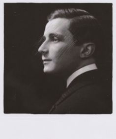 an old black and white photo of a man in a suit looking off to the side