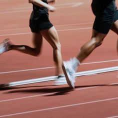 two people are running on a track