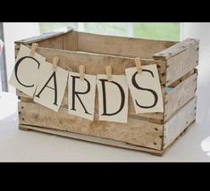 a wooden crate filled with cards on top of a table