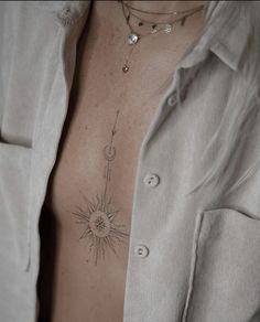 a man with a sun tattoo on his chest