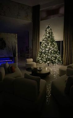 a living room filled with furniture and a christmas tree