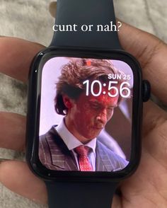 a person holding an apple watch with the image of john kerry on it's screen