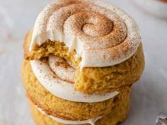 a stack of three pumpkin spice cookies with frosting on top