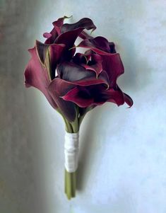 a bouquet of purple flowers in a vase