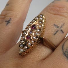 Beautiful estate victorian 14k lite rose gold with old cut center small diamond two rubies and seed pearls. unmarked acid tests for 14k. great shape. size 7. 2 grams. beautiufl estate ring.23mm by 9mm face. Estate Gold Ring As Gift, Estate Style Yellow Gold Ring, Estate Style Gold Ring Jewelry, Gold Multi-stone Pearl Ring In Fine Jewelry Style, Gold Multi-stone Pear-shaped Ring, Antique Marquise Gold Ring, Antique Gold Marquise Ring, Gold Marquise Ruby Ring Hallmarked, Gold Marquise Rings Hallmarked