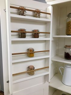 an open pantry filled with lots of food and jars on the shelves next to each other