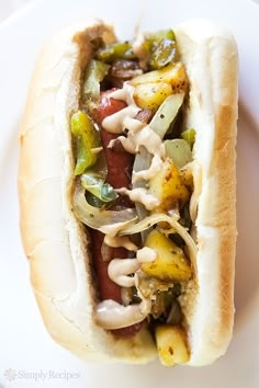 a hot dog with toppings on a plate