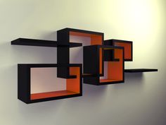 an orange and black shelf on the wall next to a white wall with two shelves