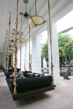 a room filled with furniture and hanging lights