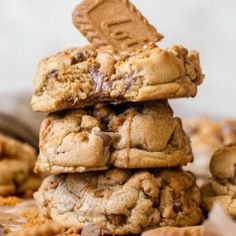 three cookies stacked on top of each other with one cookie broken in half and the other filled with chocolate chips