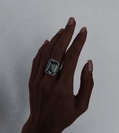 a person's hand with a ring on it