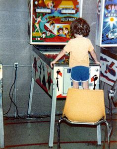 a little boy standing in front of a pinball machine with the caption, i didn't choose the pinball life me