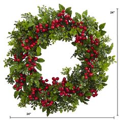 a christmas wreath with red berries and green leaves