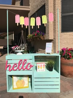 an ice cream stand with pink and yellow popsicles on it's display