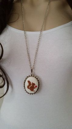 This cross stitch necklace is made of cotton thread,linen fabric,silver plated chain and silver plated apparatus, You can wear the squirrel necklace to a party and look very special. The length of this cross stitch necklace is 80 cm. Your cross stitch necklace will be put in a nice box. Squirrel Cross Stitch, Dove Bracelet, Necklace Embroidery, Squirrel Necklace, Stitch Necklace, Cross Stitch Necklace, Embroidery Necklace, Stitch Jewelry, Jewelry Cross