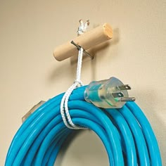 a blue hose is hanging on the wall