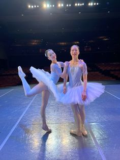 two young ballerinas are posing for the camera