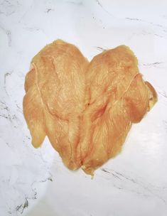 a piece of chicken sitting on top of a white counter