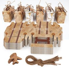 several pieces of cardboard are tied together with string and twine to make gift boxes