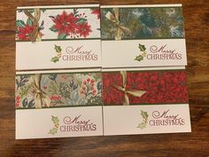 four christmas cards with bows and poinsettis on them sitting on a table