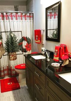 a bathroom decorated for christmas with red accessories