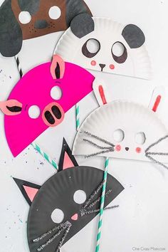 three paper plates with cat masks on them