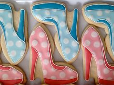 decorated cookies in the shape of high heels and polka dots are displayed on a tray