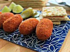 some food is sitting on a blue and white plate with limes next to it